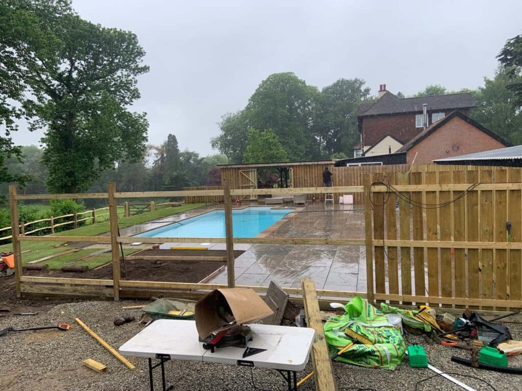 This is a photo of Bespoke custom fencing installed around a swimming pool by Fast Fix Fencing Soham