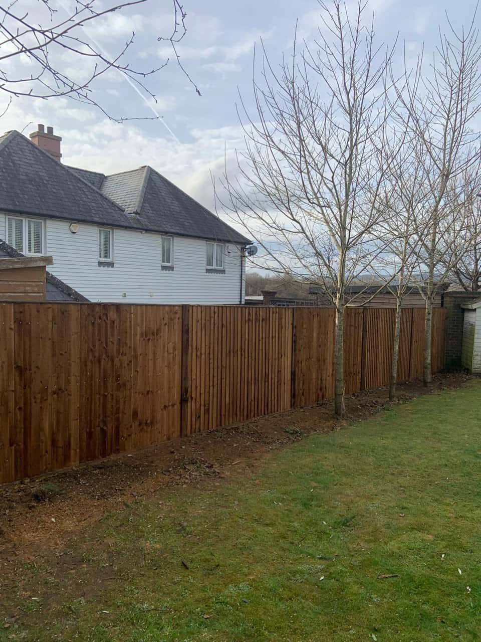 This is a photo of feather edge fencing installed in a residential properties garden by Fast Fix Fencing Soham