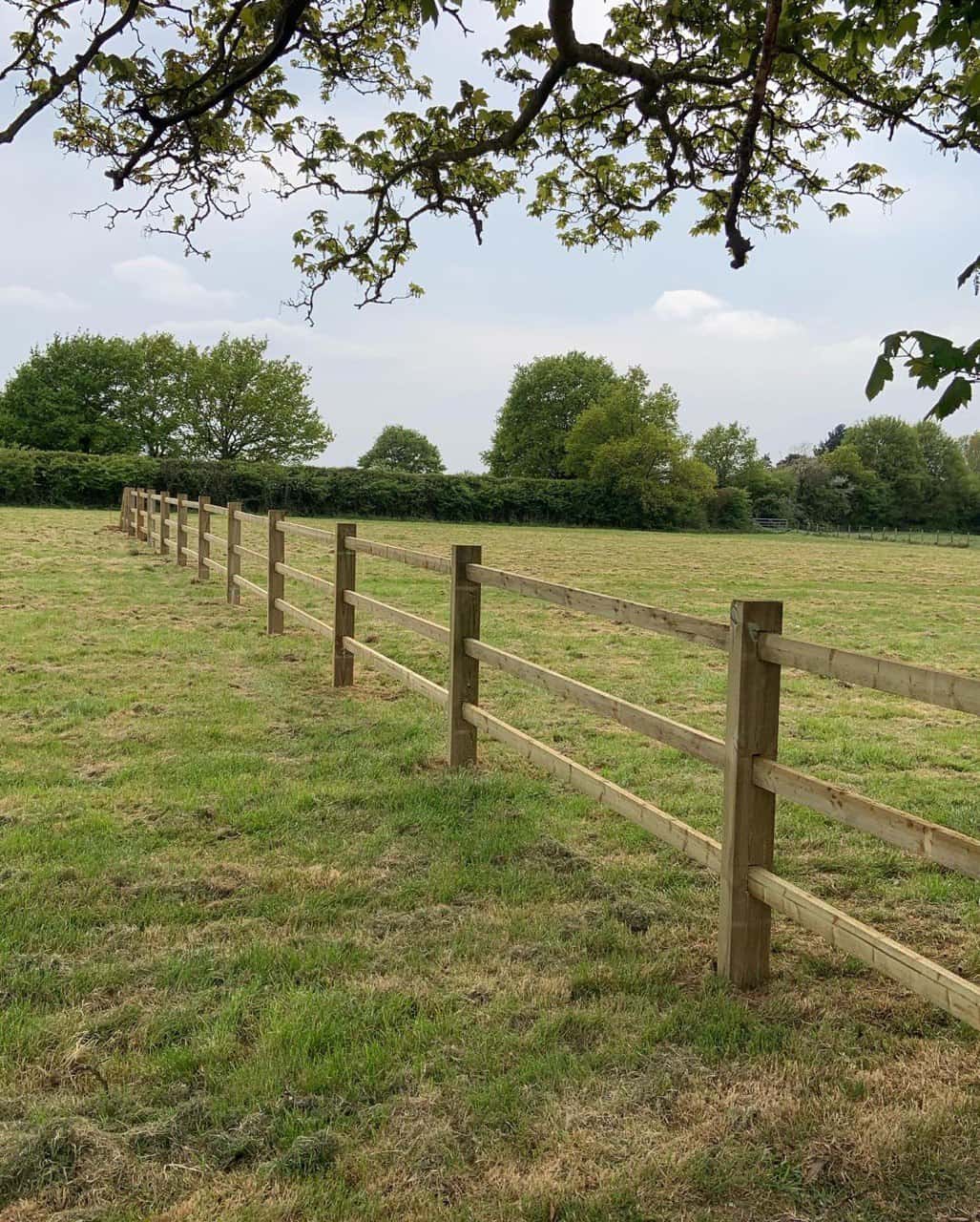 This is a photo of a post and rail fence installed in a field by Fast Fix Fencing Soham